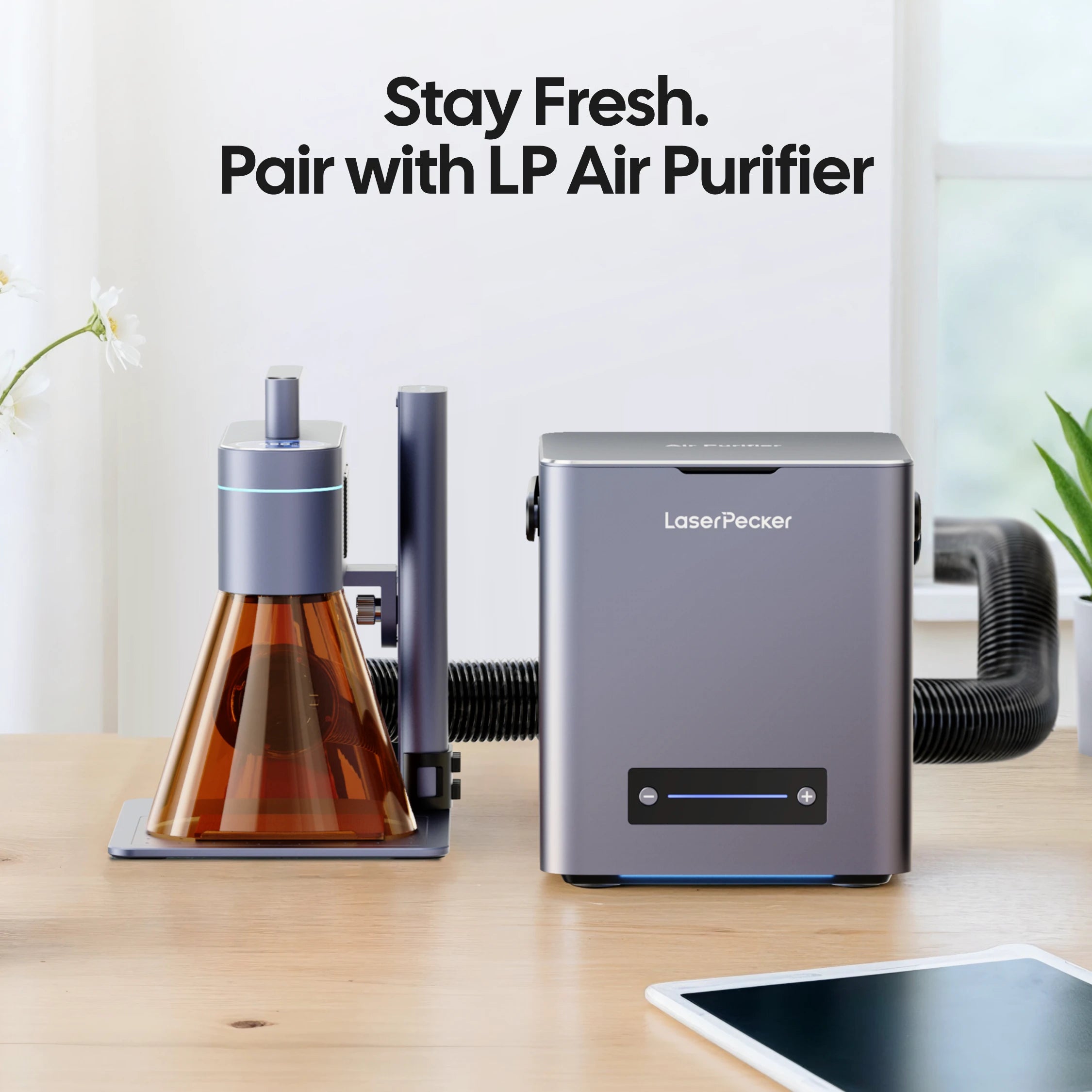 LaserPecker laser engraver for home use paired with the LP Air Purifier, connected via a hose to remove smoke and fumes, with the slogan "Stay Fresh. Pair with LP Air Purifier".