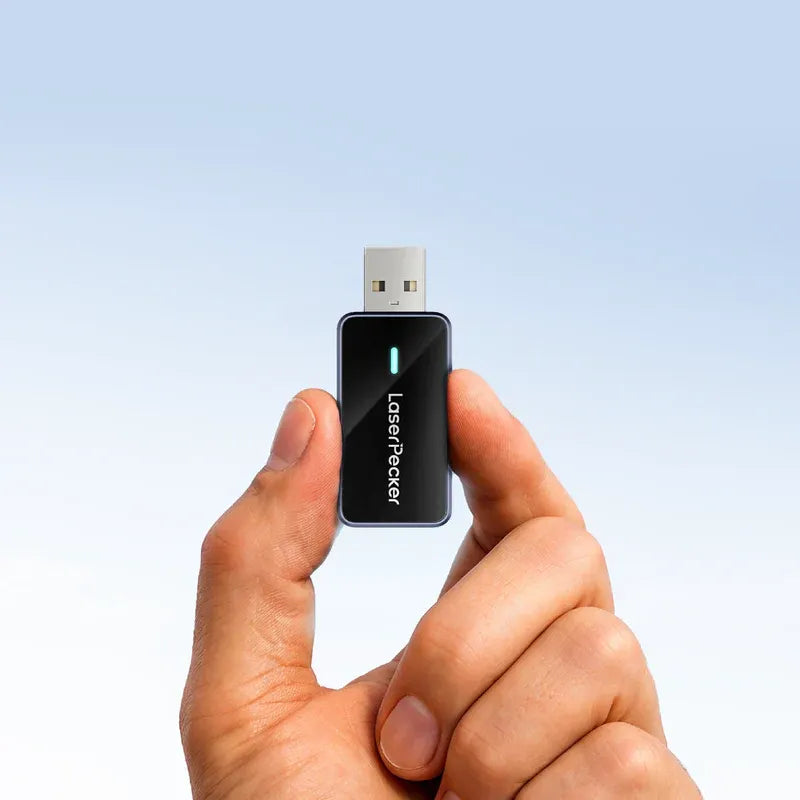 laserpecker bluetooth dongle held in hand with glowing status light ready to pair with laser engraver.