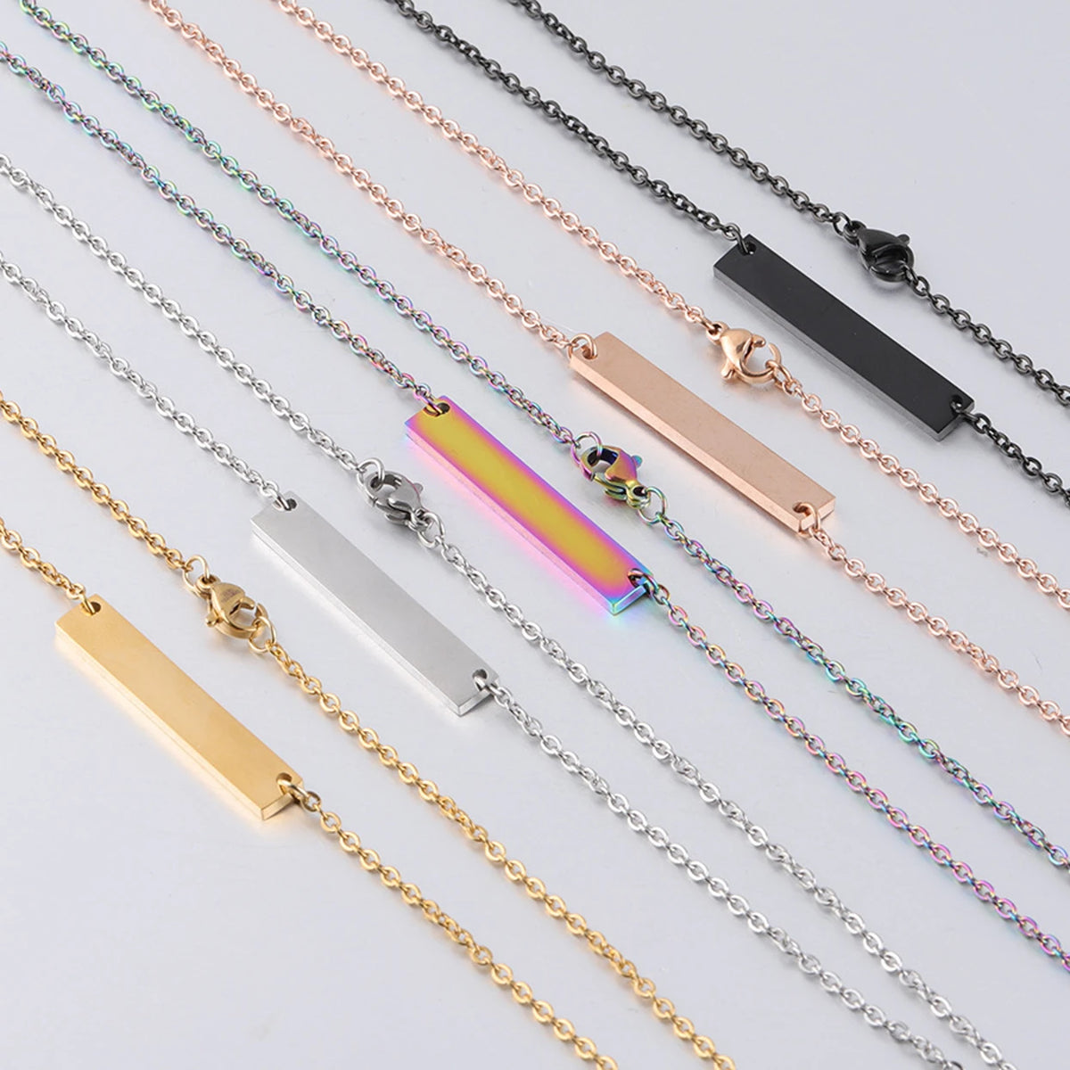 5 stainless steel horizontal bar necklace blanks scattered for laser engraving bulk order jewelry making.