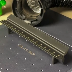 A Maker using LaserPecker LP4 to laser engrave precise scale graduations onto a 3D printed triangular ruler
