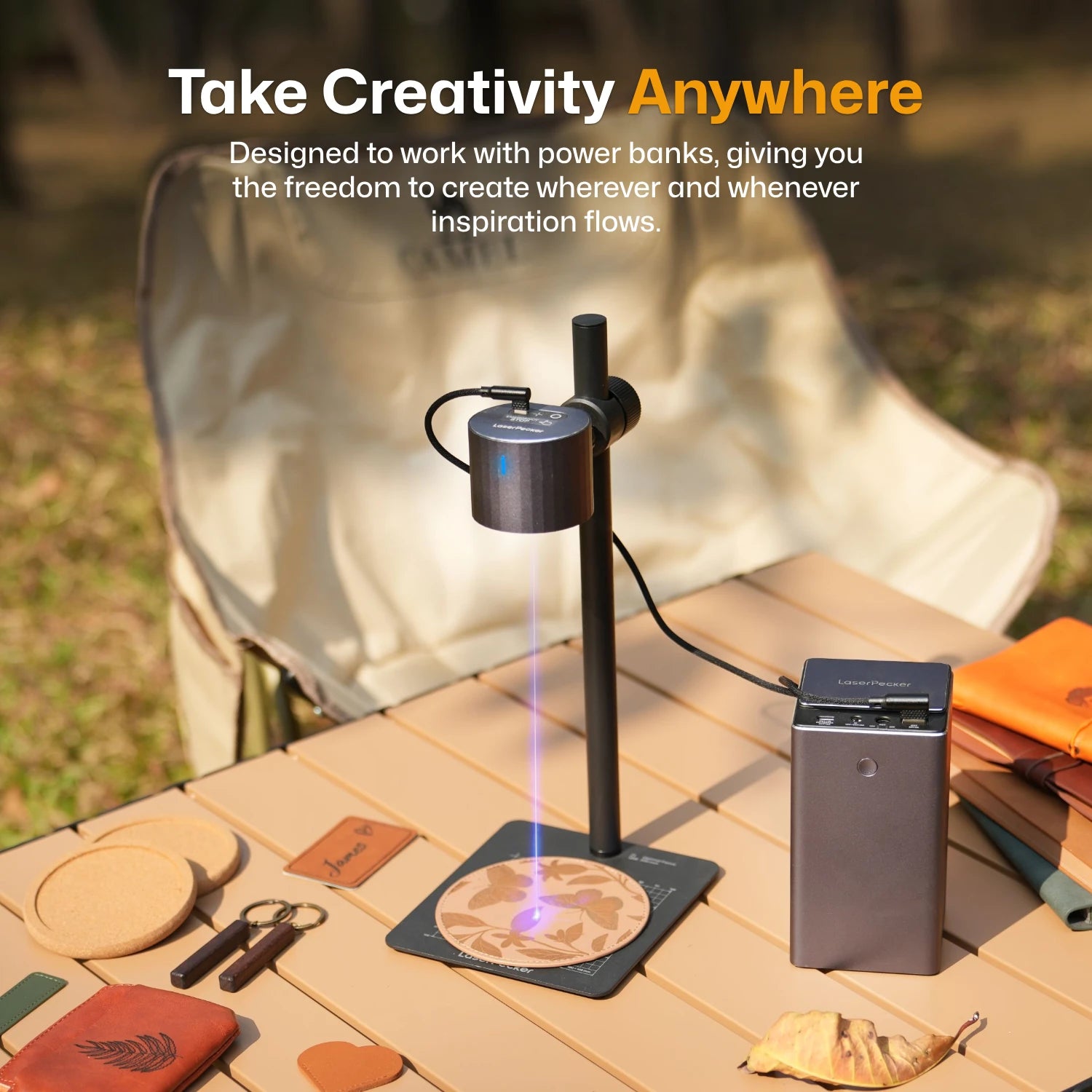 LaserPecker laser engraver powered by portable power bank on wooden surface outdoors — take creativity anywhere with freedom to create whenever inspiration flows. 
