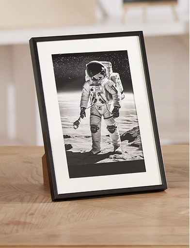Intricate space theme anodized aluminum desktop plaque featuring a floating astronaut and planets.