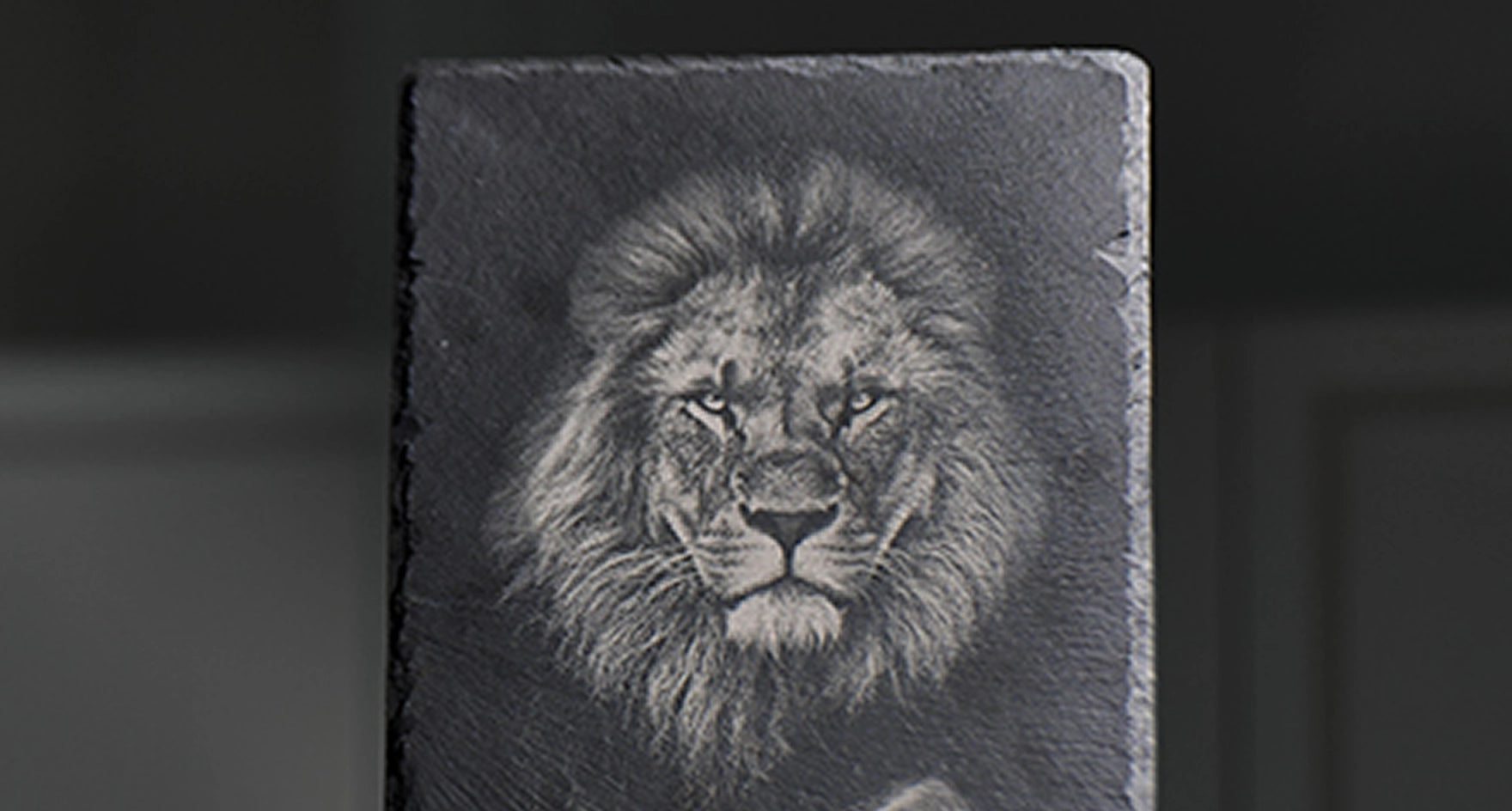 A majestic lion portrait laser engraved on a black stone slate plaque using LaserPecker LP4.