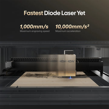 LaserPecker 40W diode laser engraver, billed as the "Fastest Diode Laser Yet", featuring a maximum engraving speed of 1,000mm/s and acceleration of 10,000mm/s², demonstrated while engraving a detailed design on a wooden workpiece.

