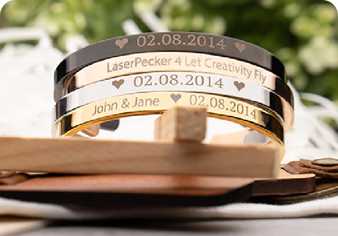 Engraved metal bracelets with personalized text.