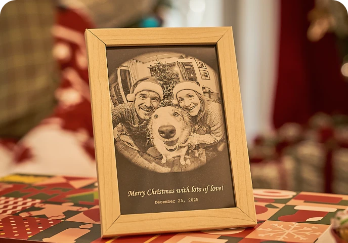 A small engraved photo plaque displayed in a Christmas setting.