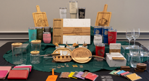 A display of personalized engraved gifts and products on a table.