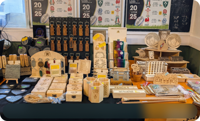 Multiple wooden engraved items displayed on a table.