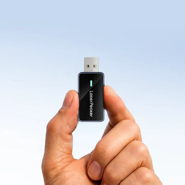 laserpecker bluetooth dongle held in hand with glowing status light ready to pair with laser engraver.