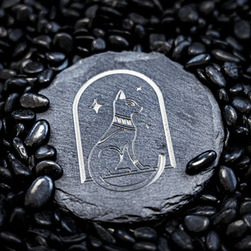 black round slate coaster with laser engraved cat symbol for cat lover gift or pet memorial coaster set.