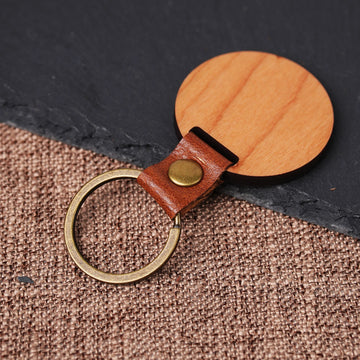back side of cherry wood circular keychain blank showing wood grain for laser engraving diy keyring.