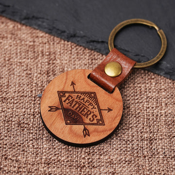 cherry wood circular keychain with laser engraved name and heart for personalized gift for fathers day.