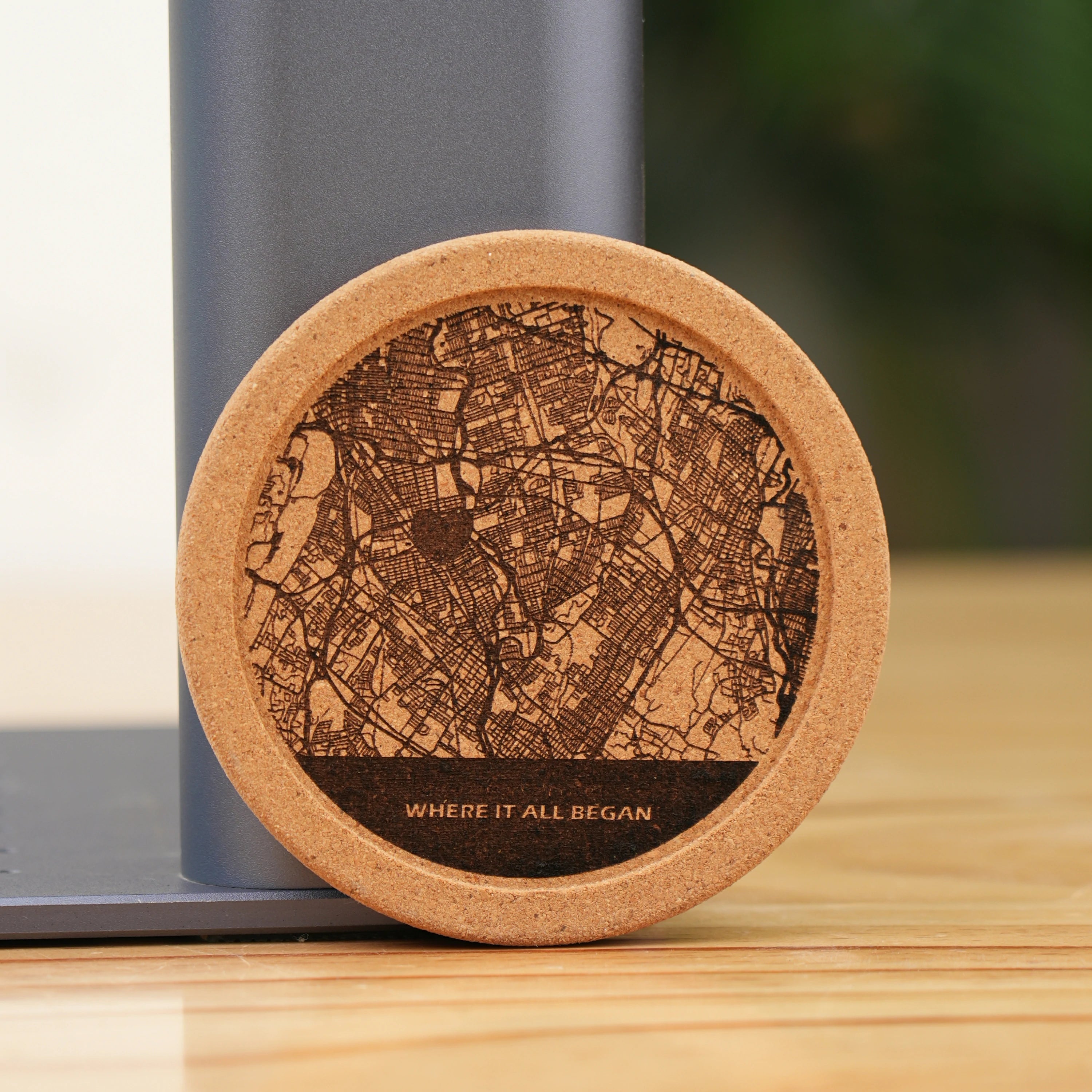 A laser-engraved cork coaster featuring a detailed city street map design, paired with the heartfelt phrase "WHERE IT ALL BEGAN". It’s presented as a personalized keepsake ideal for commemorating meaningful locations or memories.