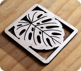 LP2 Plus cutting hollow leaf pattern on wooden coaster.