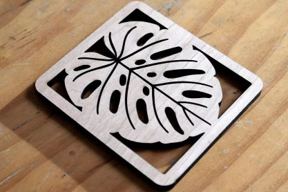 LP2 Plus cutting hollow leaf pattern on wooden coaster.