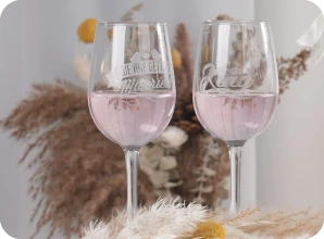 LaserPecker LP2 Plus with rotary extension engraving custom names and designs on clear glass cup and drinking glass, 360° rotation for personalized barware and wedding favors.